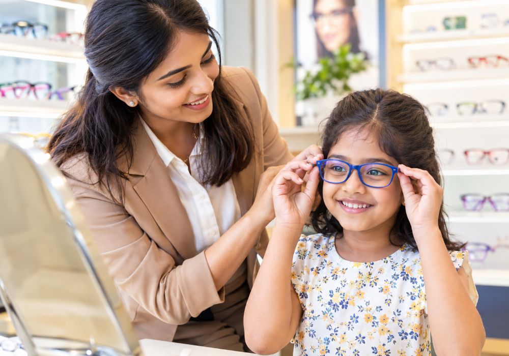 Young girl wearing pink Jude Eyewear sunglasses.